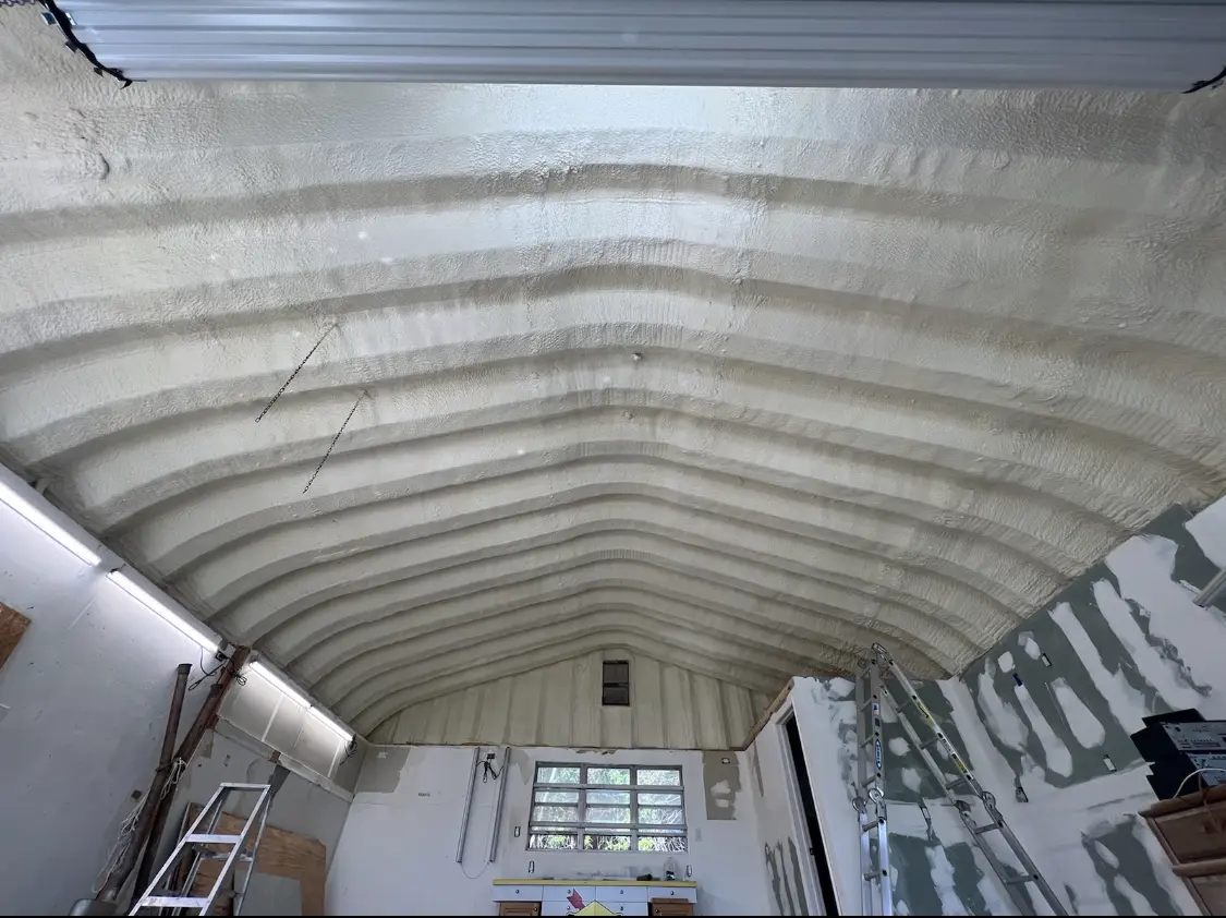 Spray polyurethane foam applied to the underside of a metal roof deck in Coos Bay